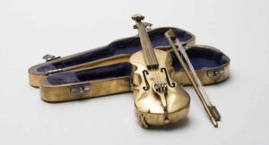 A tiny gold violin and case