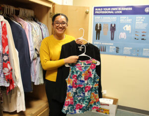 Mariel Aleman displays clothing items in the Career Closet