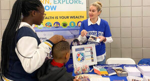 Claudia Paiva provides information at the recent Wellness Expo at Worcester State