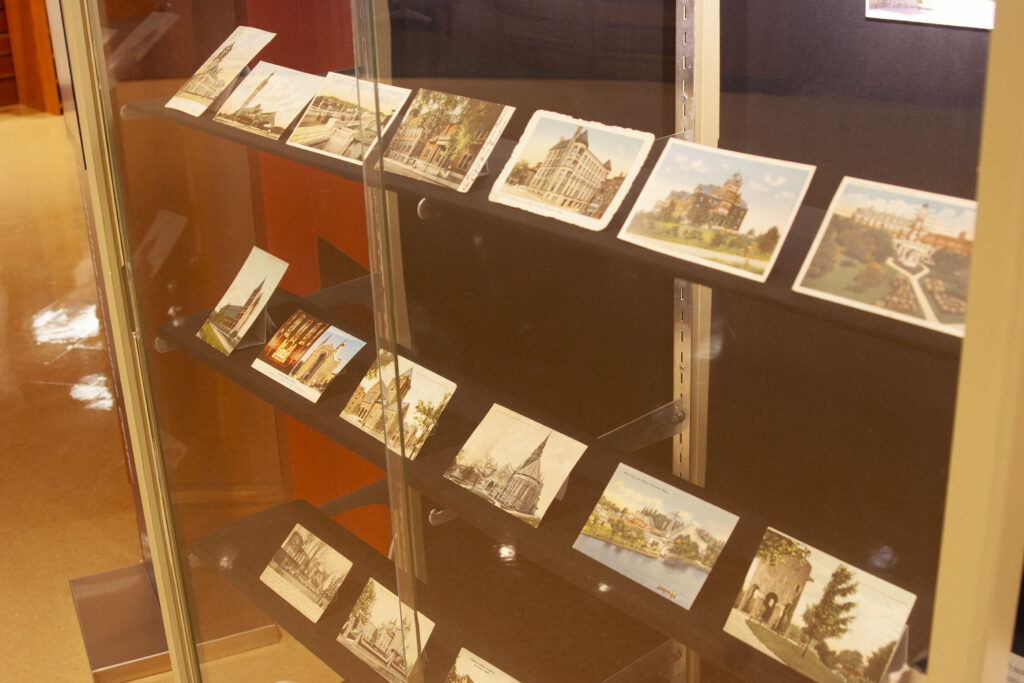 display case with 3 rows of postcards on exhibit