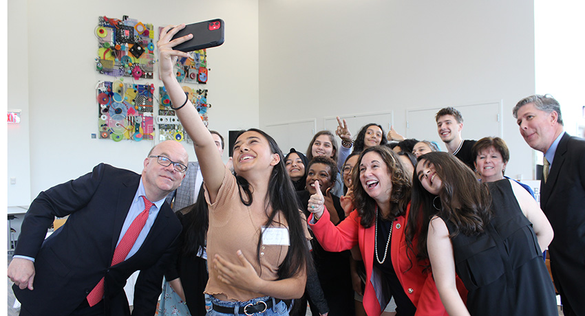 A student takes a selfie of the group at the Early College roundtable