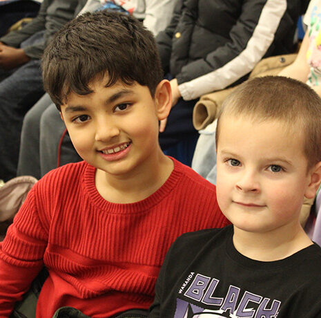 two young students in the stands at the WSU gym