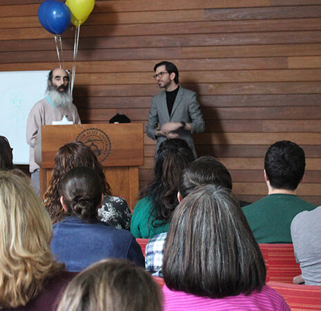 Lecture attendees listen to Hy Ginsberg and Riley Maguire