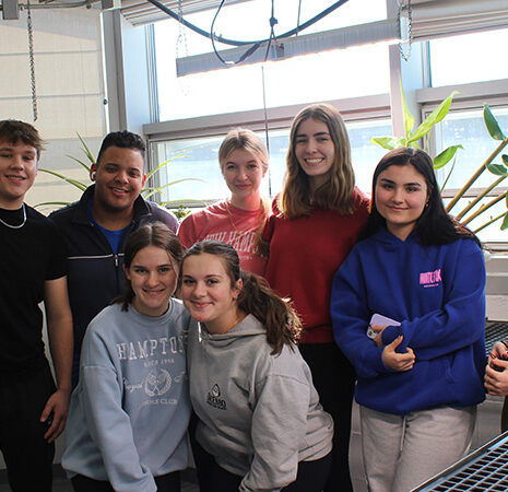 A group of students in the greenhouse