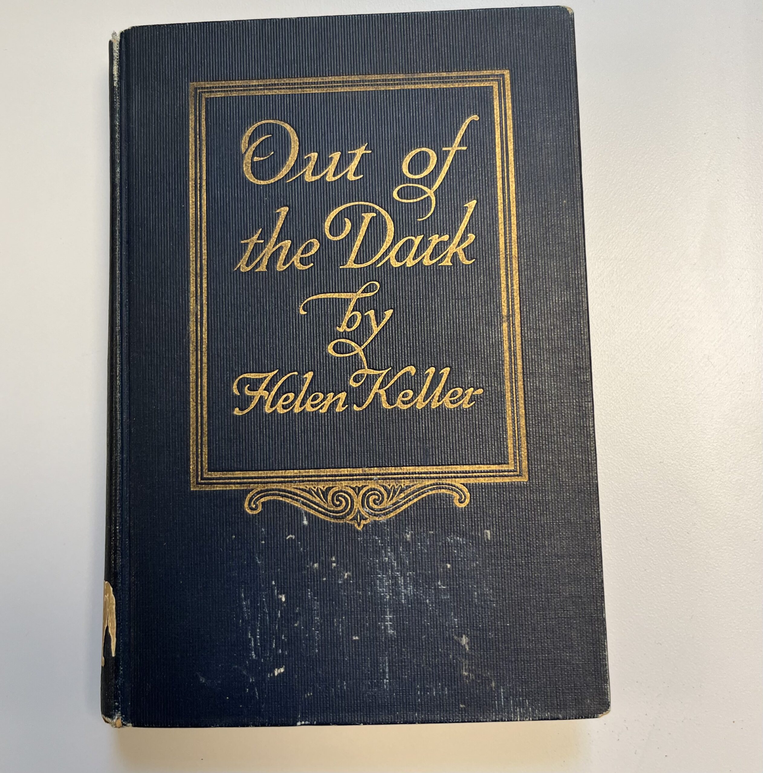 The cover of an old book, Out of the Dark by Hellen Keller