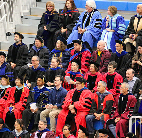 Worcester State faculty in full regalia in teh stands