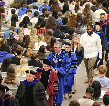 The stage party processes into the venue