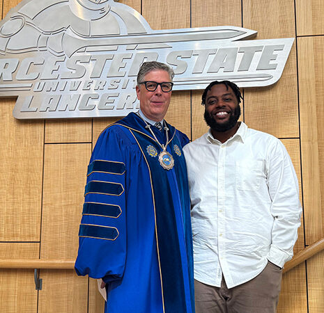 President Maloney and Convocation keynote speaker Dejour Hollins on the stairs in the Wellness Center