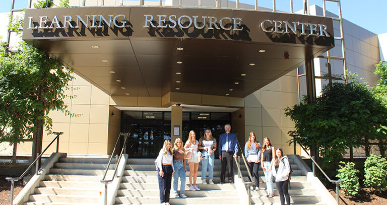 Library Director Matt Bejune with students on the steps of the LRC