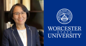 A woman in a blazer and glasses smiles in front of shelves. Next to her is the Worcester State University logo and text on a blue background.
