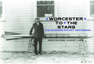 Black-and-white photo of a man standing beside a rocket in front of a building, with event text about the Goddard Rocket Centennial in Worcester, March–August 2026.