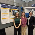 Three women stand in front of a research poster titled "Promoting Student Learning Outcomes and Community Outreach" at an indoor event or conference.